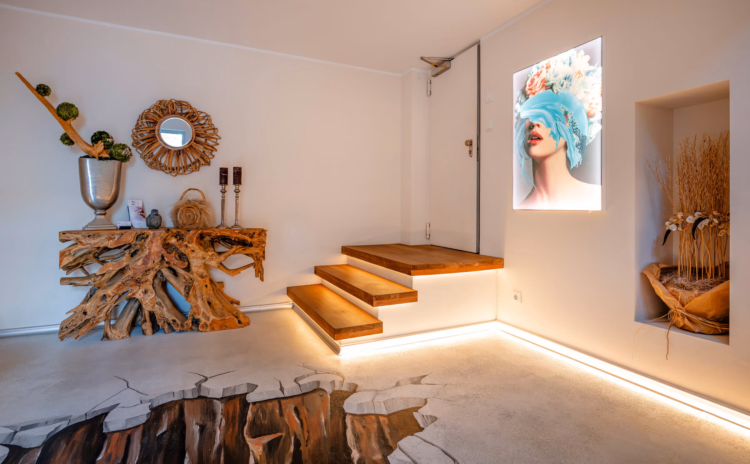 Einladender Eingangsbereich mit beleuchteter Treppe im Studio von Belium Beauty